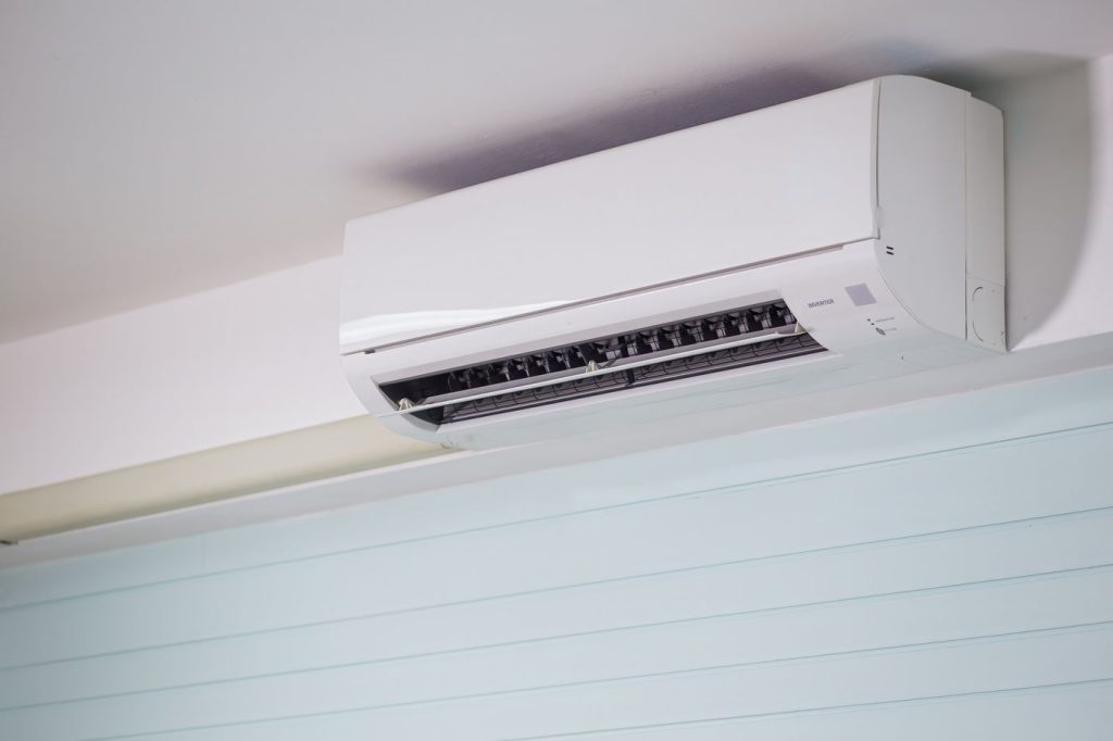 Clean white wall-mounted split air conditioner in a modern room