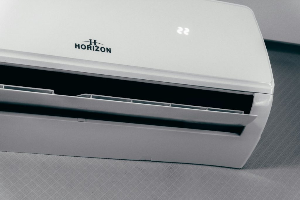 White split air conditioner with its display showing 22 degrees